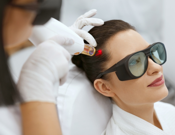 Woman undergoing laser hair rejuvenation during perimenopause, scheduled through spa management software.